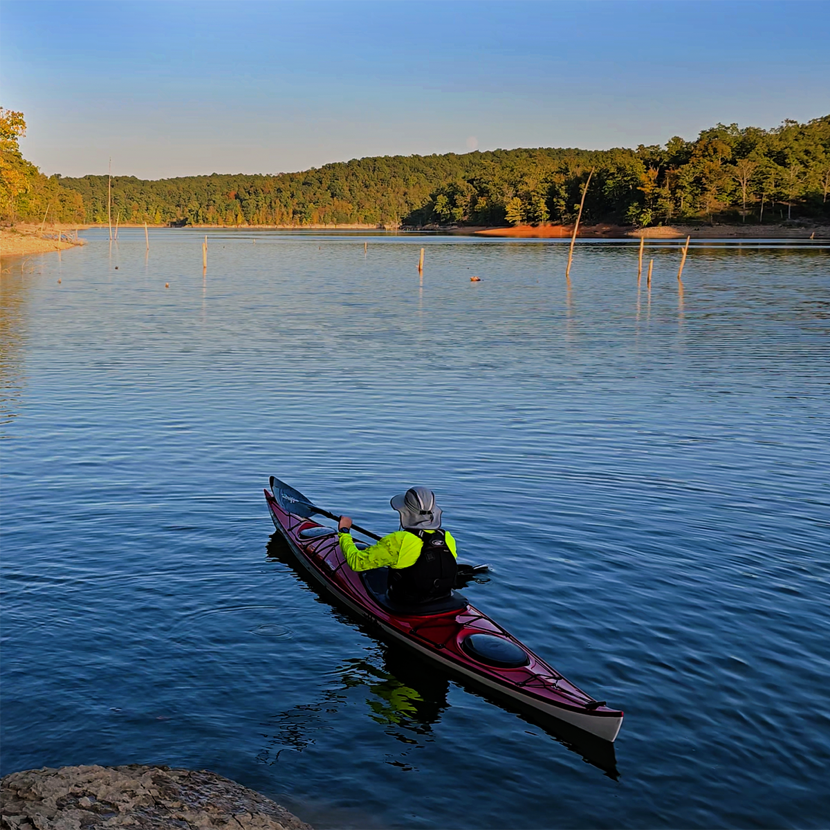 Kayaker on water wearing Paragon Cayman Hi-Visibility Sun Shirt Safety Green